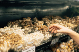Variety of mushrooms in fridge case ready for sale