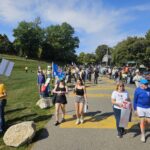 Protestors making their way down the Black Lives Matter driveway down from Cross Street to Riverside Park in Ypsilanti, for the No Kings protests on October 18. Photo by Drew Saunders.