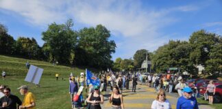 Protestors making their way down the Black Lives Matter driveway down from Cross Street to Riverside Park in Ypsilanti, for the No Kings protests on October 18. Photo by Drew Saunders.