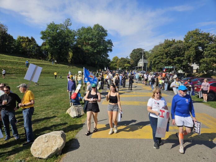 Protestors making their way down the Black Lives Matter driveway down from Cross Street to Riverside Park in Ypsilanti, for the No Kings protests on October 18. Photo by Drew Saunders.